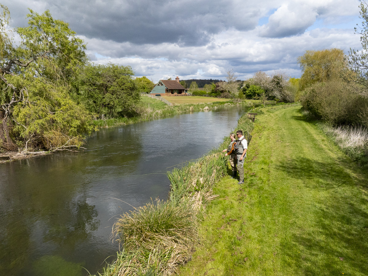 Picture of the river Kennet and two people fishing at the Wilderness fishing beat