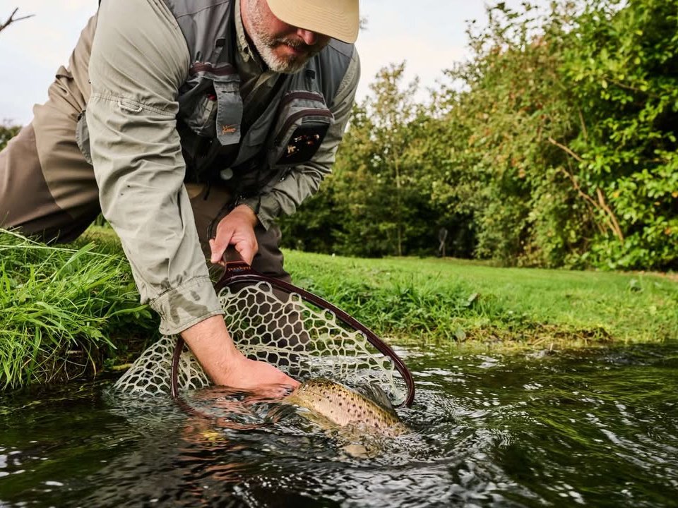 Ben Bangham netting a brown trout