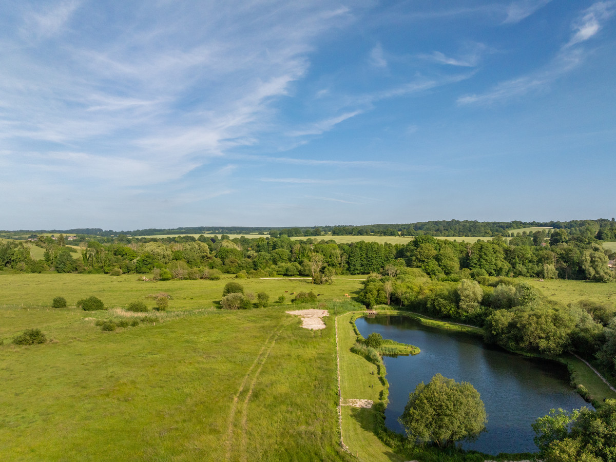 Aerial shot of the fishing lake at Bossington Estate